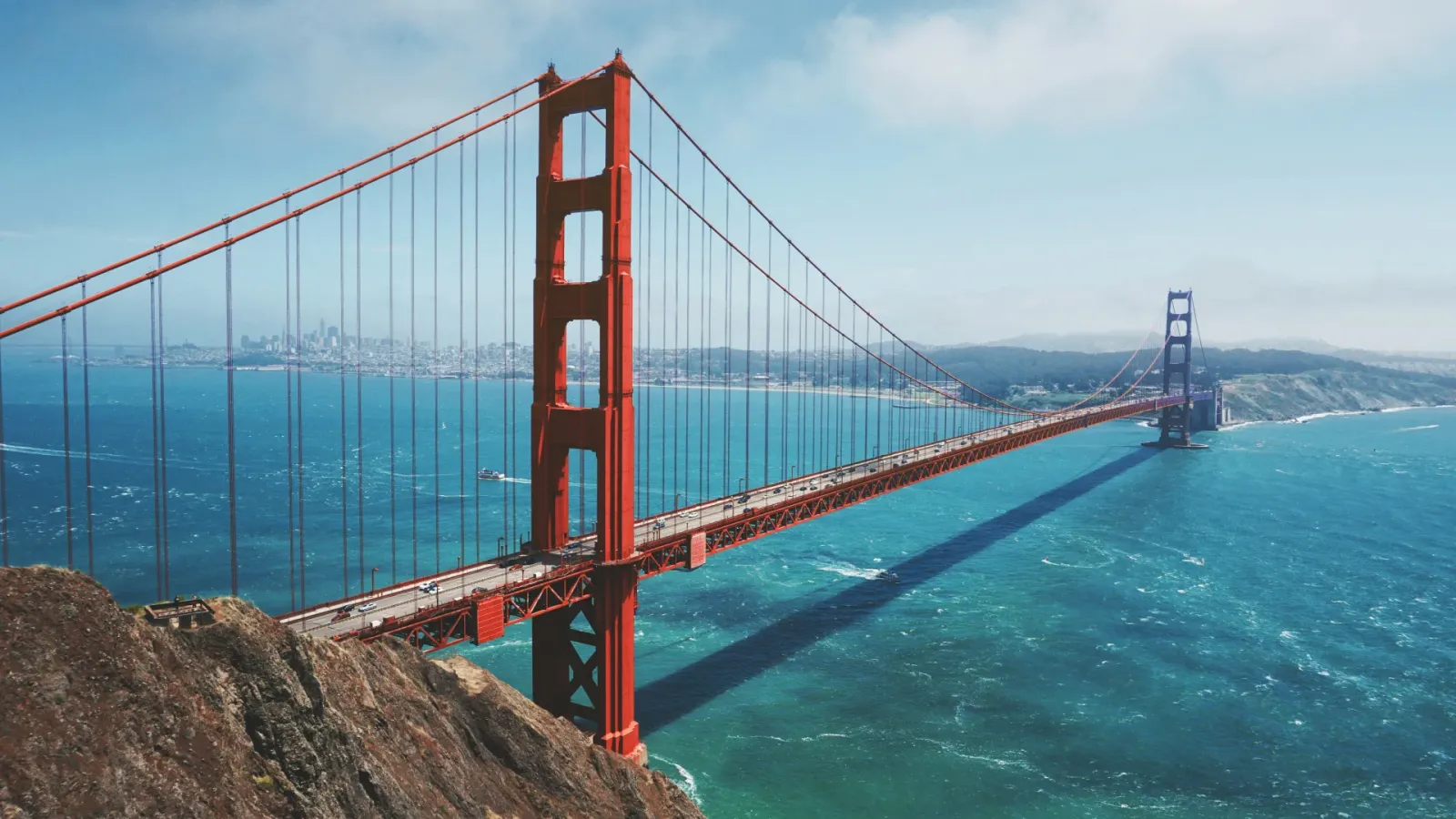 Aerial view of the Golden Gate Bridge spanning San Francisco Bay; CA; with the city skyline visible in the background.