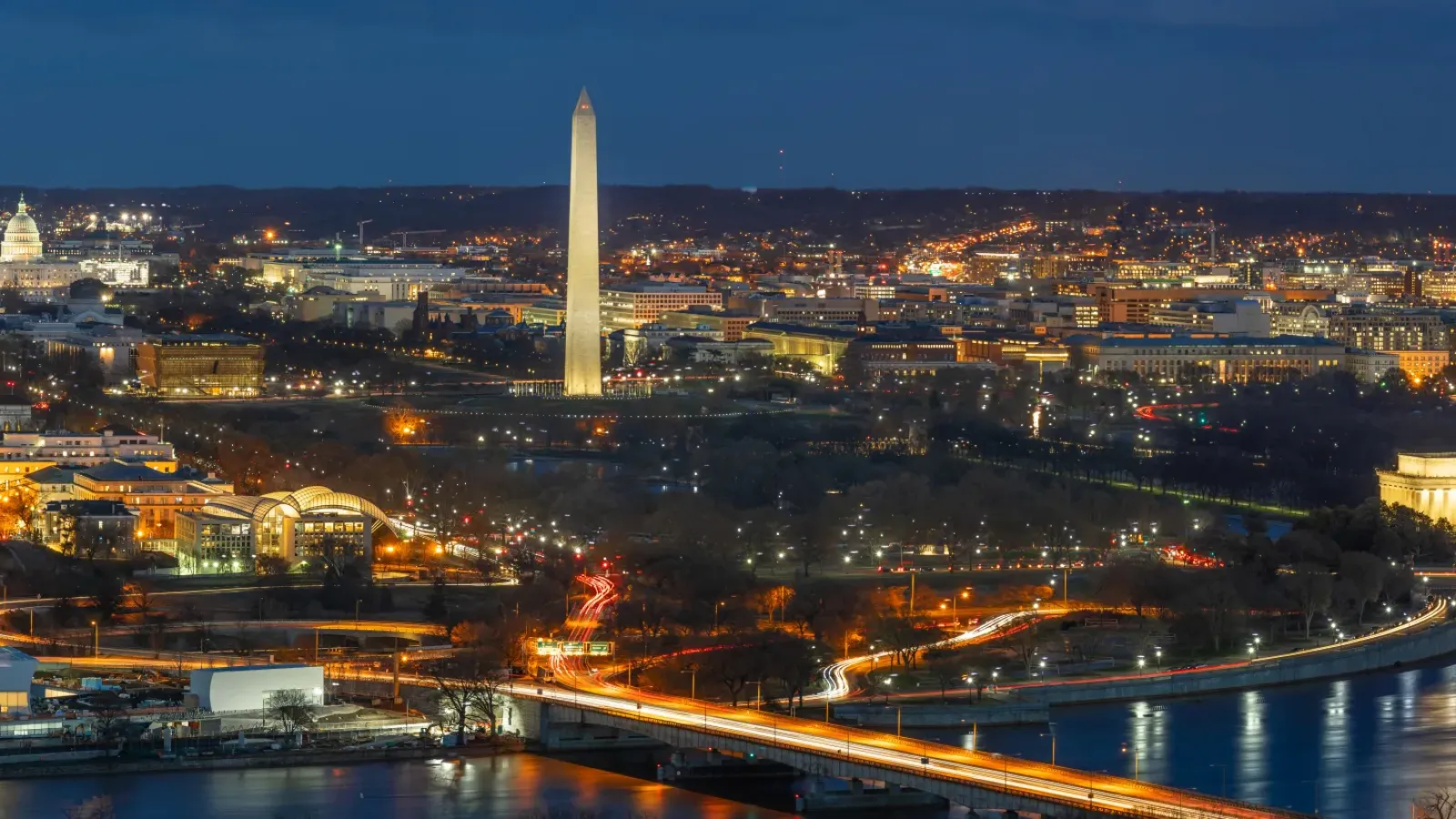 Washington DC skyline at night featuring the Washington Monument Lincoln Memorial and Capitol Building along the Potomac River