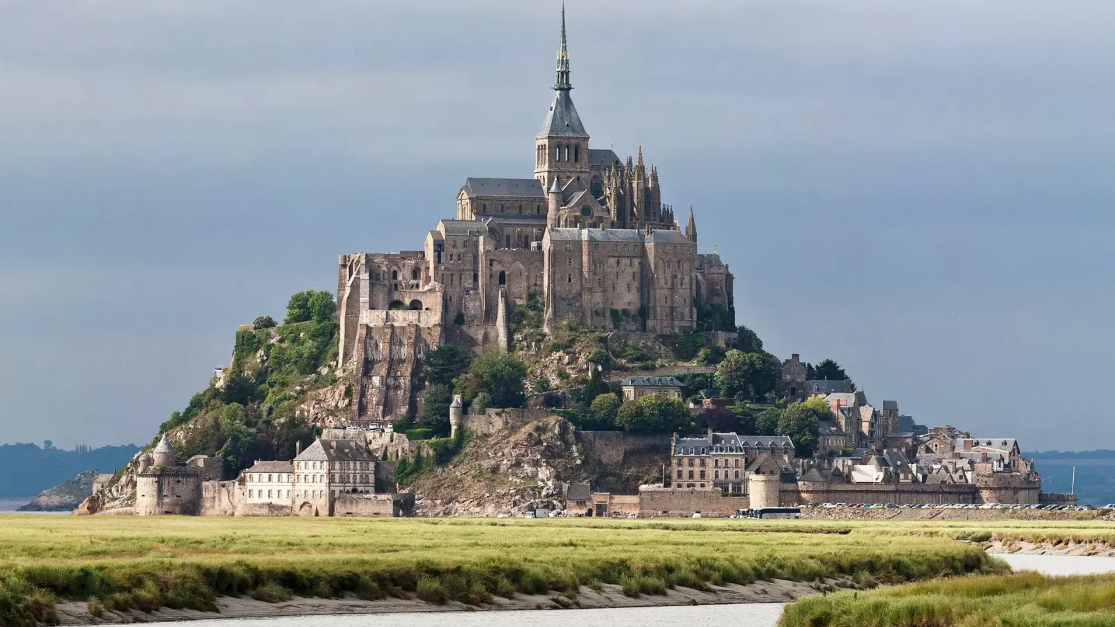 The abbey of Mont Saint-Michel in Normandy, France, rising above the salt marshes and tidal channels of the bay