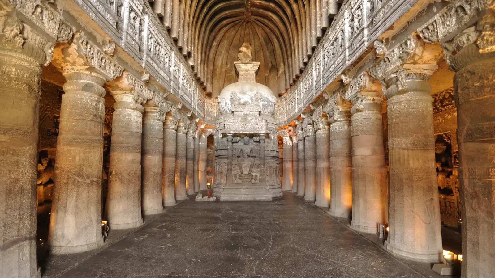 The pillared chaitya hall of Cave 26 at Ajanta with its carved stupa and vaulted ceiling.