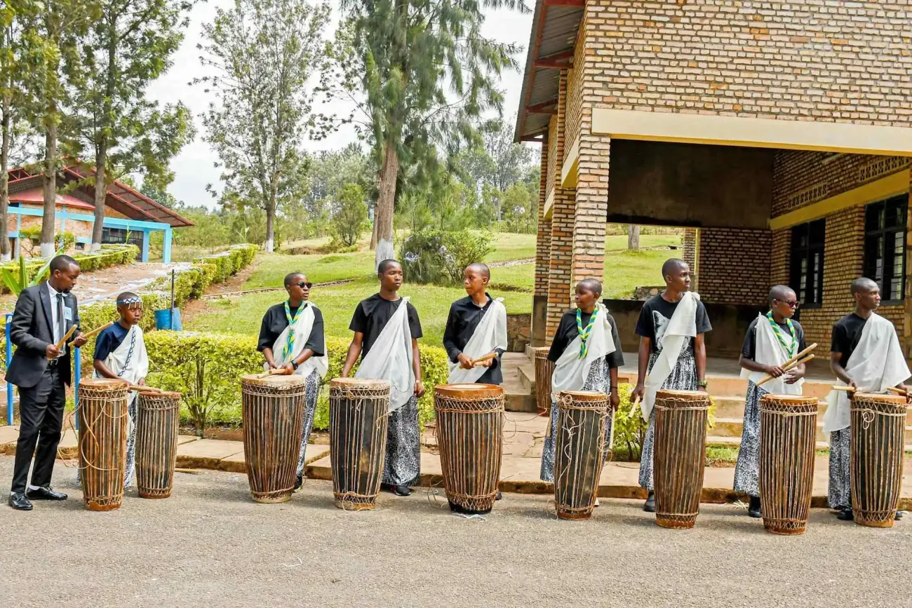 Five people playing traditional drums in rwanda