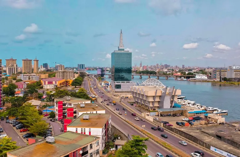 An aerial view of the Lagos skyline, with a prominent skyscraper