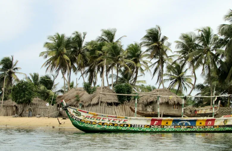 Agbeyeye canoe on a beach in Ghana featured
