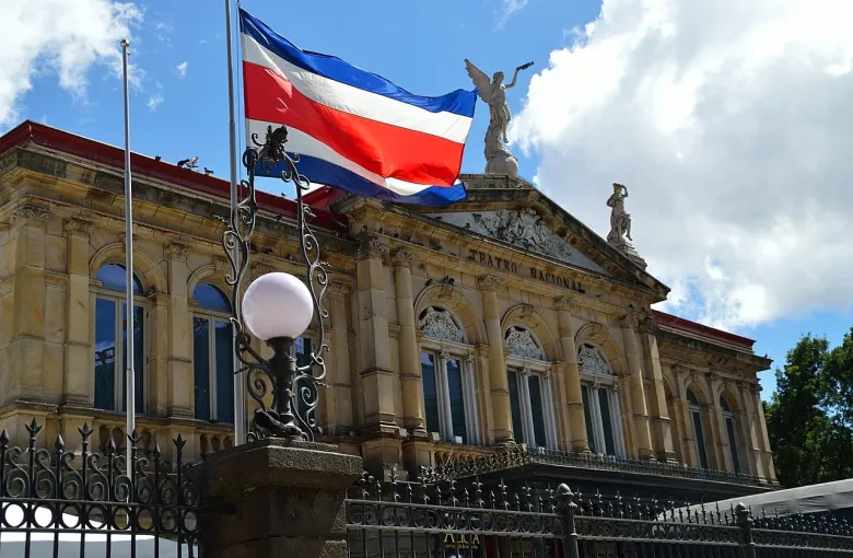 The National Theatre of Costa Rica in San Jose, with the national flag flying above its facade.