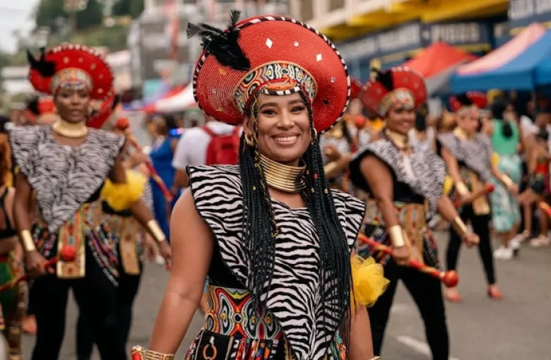Carnival dancers in feathered headdresses during a street parade on the Costa Rican Caribbean coast.