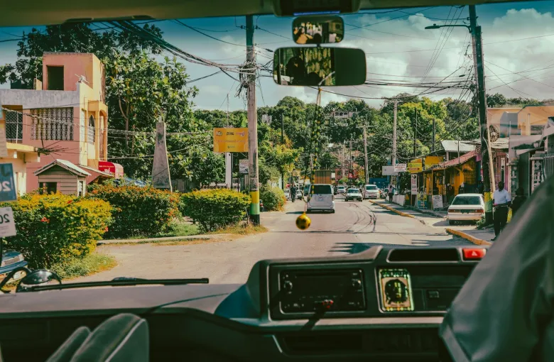 Vehicle traveling down a street in Jamaica for a destination guide