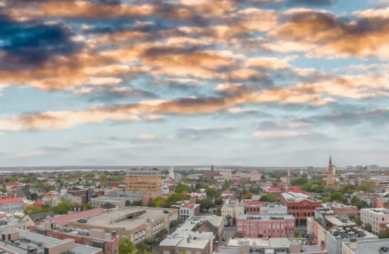Aerial panoramic view of Charleston South Carolina waterfront skyline at sunset with historic church steeples and harbor