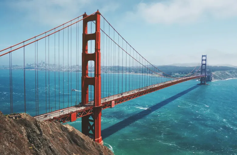 Aerial view of the Golden Gate Bridge spanning San Francisco Bay; CA; with the city skyline visible in the background.