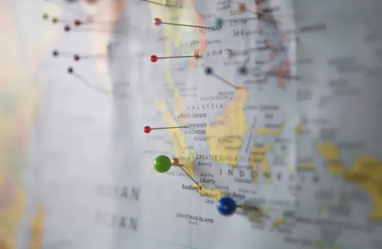 Map of Southeast Asia with colorful pushpins marking travel support destinations including Vietnam; Malaysia; Singapore; a...