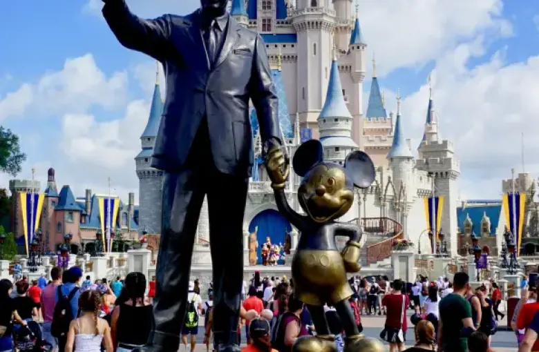 Partners statue of Walt Disney and Mickey Mouse with Cinderella Castle behind it at Magic Kingdom in Orlando; FL.