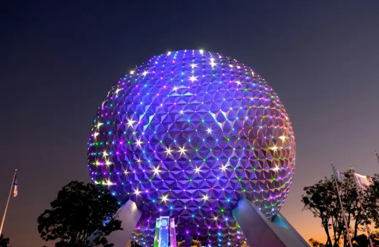 Spaceship Earth geodesic sphere at EPCOT illuminated with colorful LED lights at dusk in Orlando; FL.