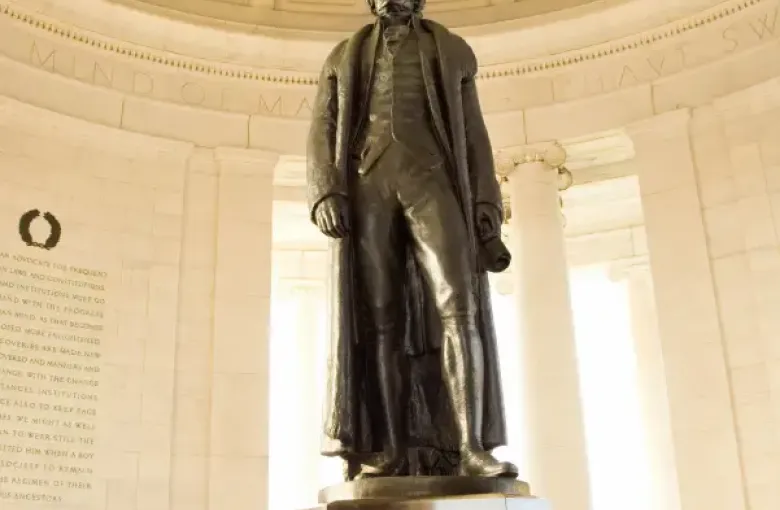 Bronze statue of Thomas Jefferson inside the domed Jefferson Memorial rotunda in Washington; DC; with inscribed quotes on...