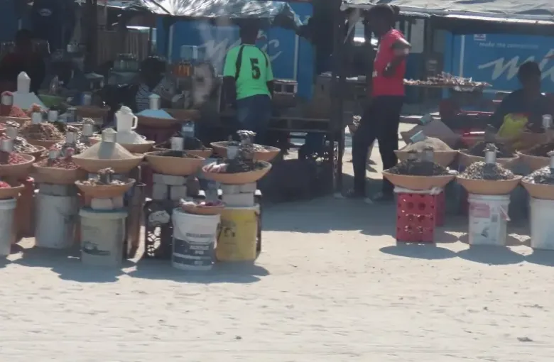 Traditional foods and grains displayed in open containers at a Namibian open-air market.
