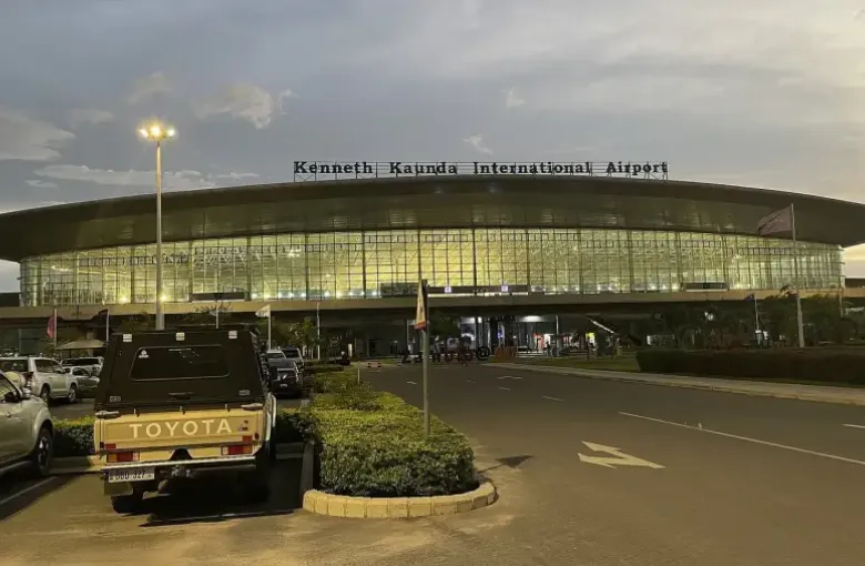 The terminal building at Kenneth Kaunda International Airport in Lusaka Zambia at dusk.