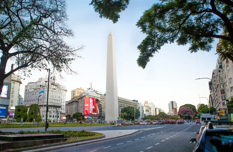 Jacaranda trees in full purple flower lining Avenida 9 de Julio in Buenos Aires.