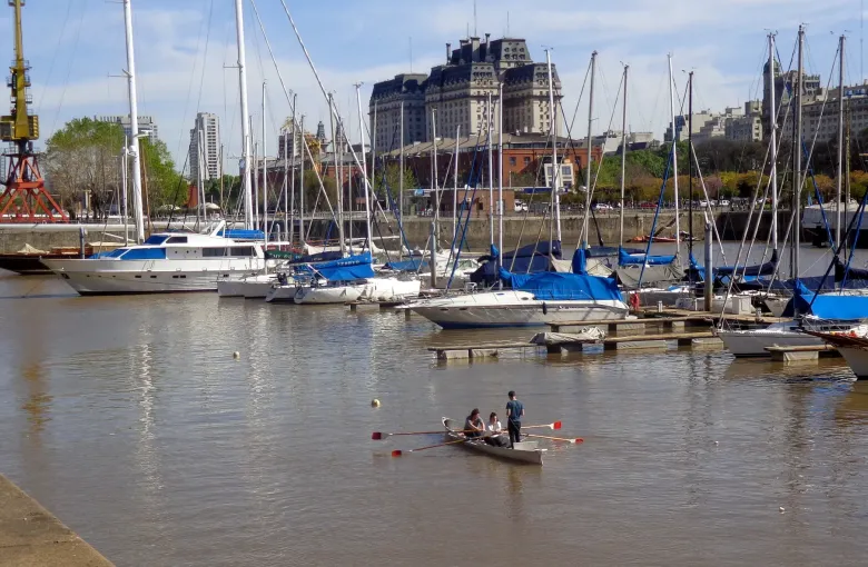 The level brick promenade along the docks at Puerto Madero in Buenos Aires with converted warehouses beside it.