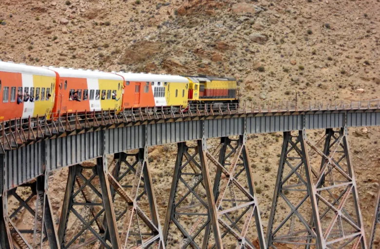 The Tren a las Nubes crossing the curved steel La Polvorilla viaduct high in the mountains of Salta Province.