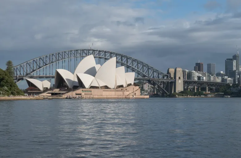 The Sydney Opera House and the Harbour Bridge seen together across the water on a clear day.