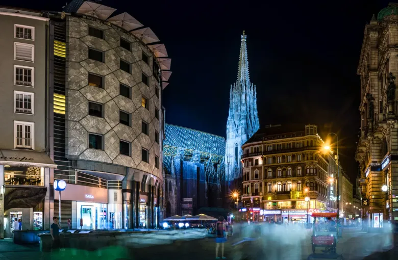 The spire of St Stephen's Cathedral lit at night above the Stephansplatz in the historic centre of Vienna.