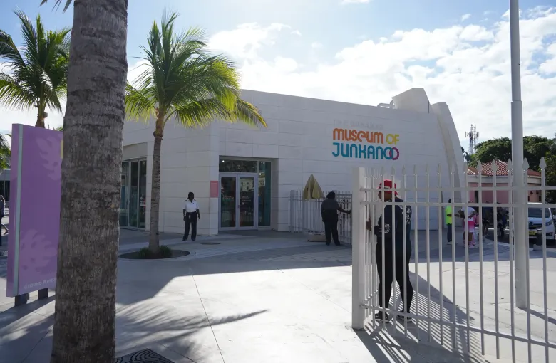 The level paved approach to the Museum of Junkanoo in Nassau, with wayfinding signage and staff at the door.