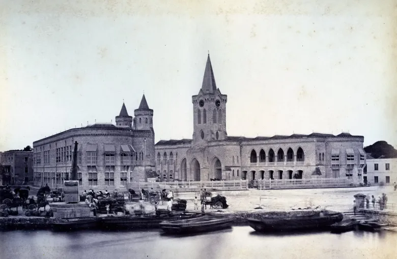 A photograph of about 1880 showing the Parliament Buildings seen from the water in Bridgetown.