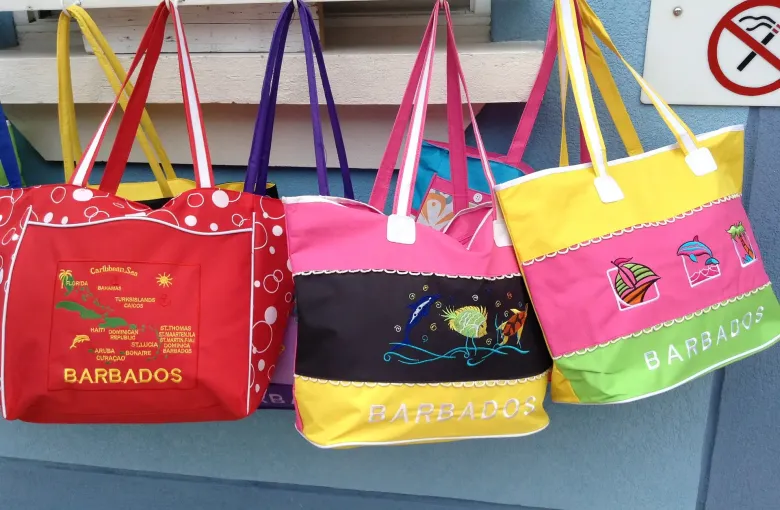 Souvenir bags printed with the name Barbados hanging outside a shop in Bridgetown.