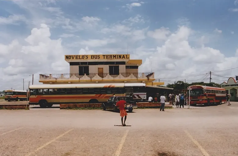 Repainted former school buses drawn up outside Novelo's Bus Terminal in Belize City.