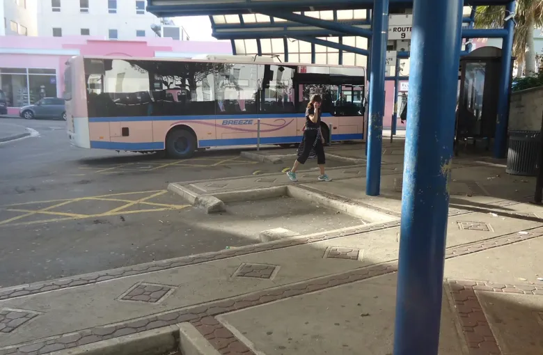 A bus at the numbered route bays of the Hamilton terminal, where visitors board without a car.