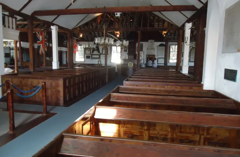 The cedar box pews and exposed roof timbers of St Peter's Church in St George's, Bermuda.