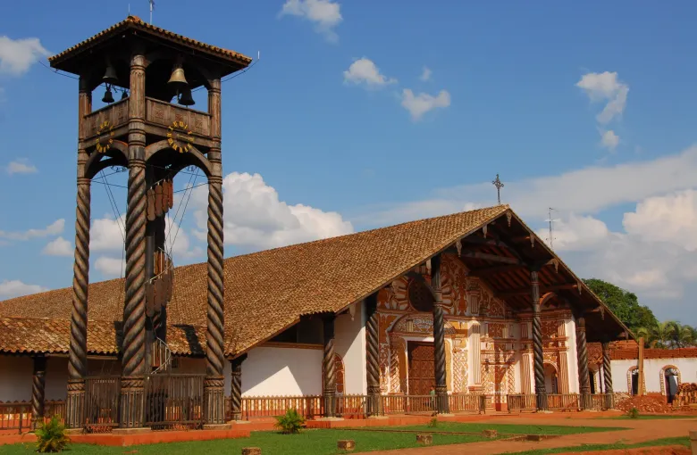 The Jesuit mission church at Concepcion with its painted facade, carved spiral columns and freestanding wooden bell tower.