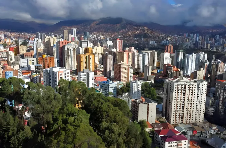 Apartment towers fill the bowl of central La Paz with the canyon rim and hillside districts rising behind.