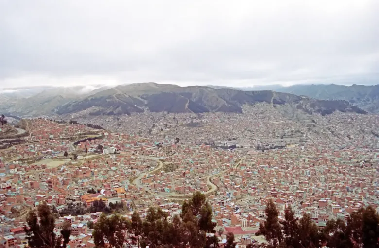 The dense bowl of La Paz seen from the rim above, with roads winding down the valley sides.