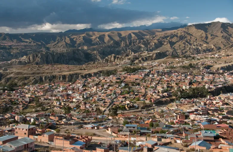 Evening light on houses in southern La Paz below the eroded rock spires of the surrounding valley.