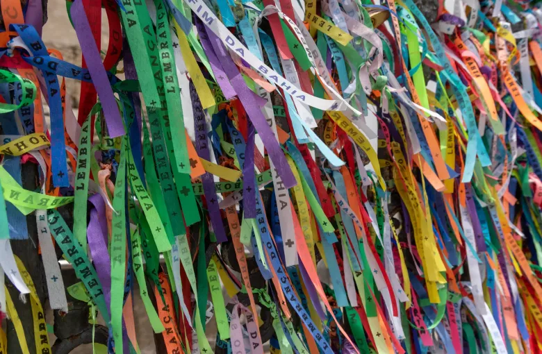 Hundreds of printed ribbons in many colours tied to a railing at the church of Nosso Senhor do Bonfim in Salvador.