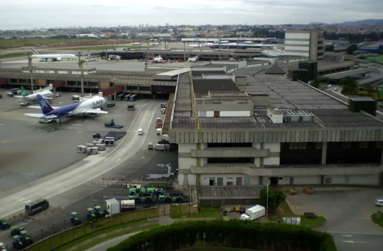 The terminal buildings and apron of Guarulhos International Airport outside Sao Paulo with aircraft at their stands.