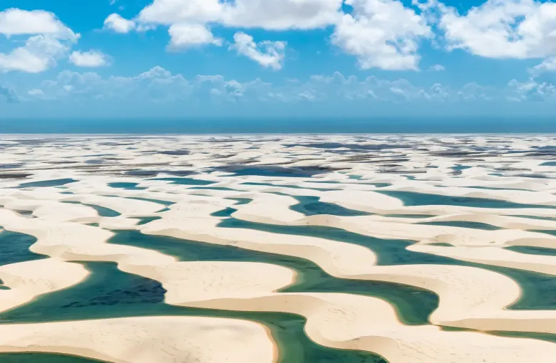 White dunes in the Lencois Maranhenses with long blue-green lagoons lying between them after the rains.