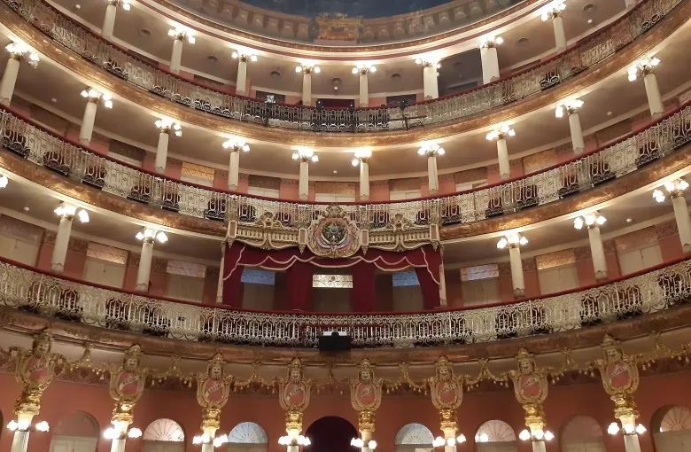 The tiered balconies and painted ceiling of the auditorium inside the Teatro Amazonas at Manaus.