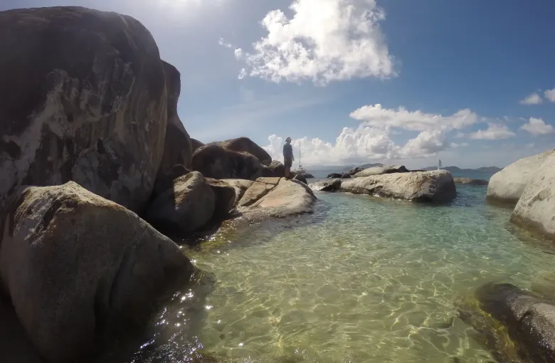 Granite boulders the size of houses at The Baths on Virgin Gorda, enclosing a clear shallow tidal pool.