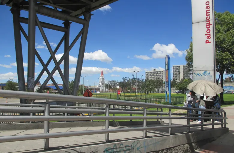 A long step-free access ramp with metal railings leading up to the Paloquemao TransMilenio station in Bogota.