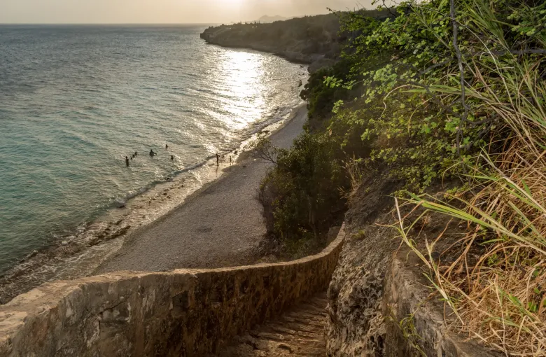 A limestone shore dropping to clear water at the 1000 Steps dive site, Curaçao.