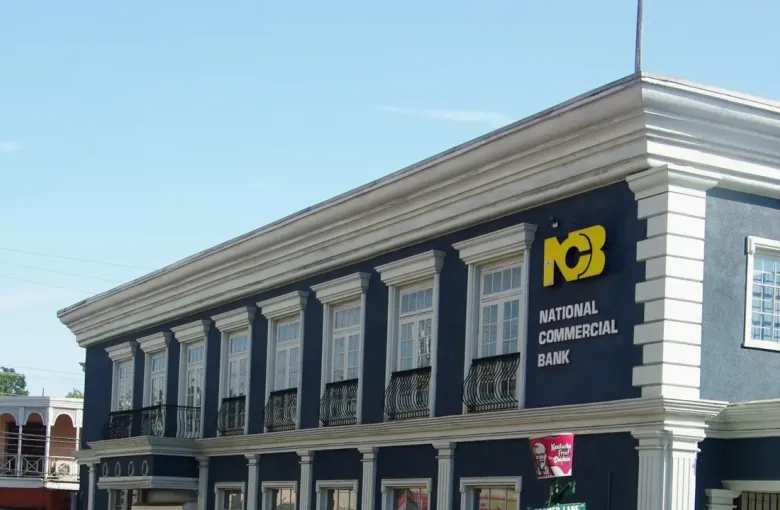 The National Commercial Bank building on Sam Sharpe Square in Montego Bay, beside a credit union sign.