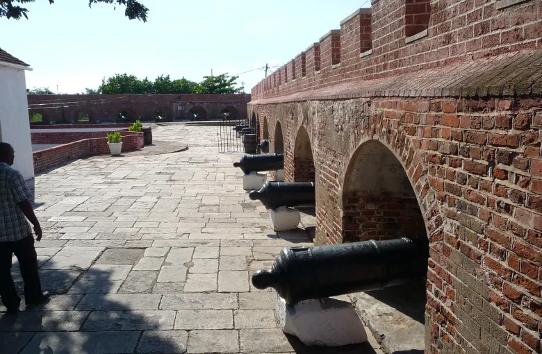 Cannon stand in a row along the brick parapet of the gun deck at Fort Charles in Port Royal.