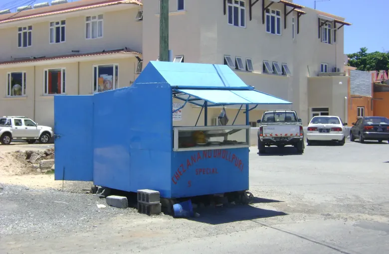 A blue street-food cart of the kind dholl puri is sold from, parked on a road in Mauritius.