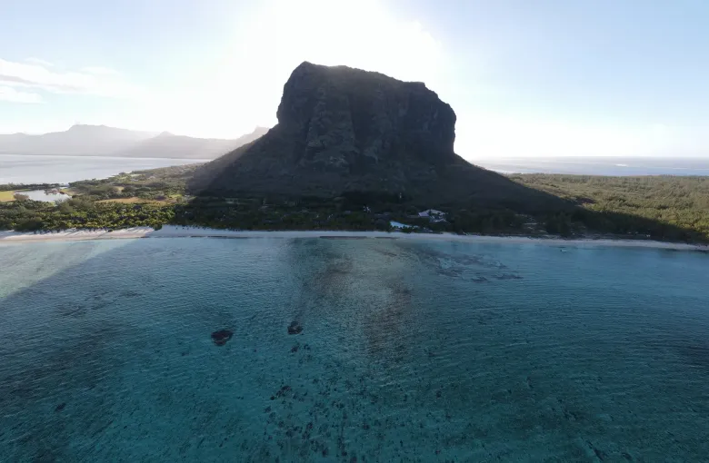 The sheer basalt block of Le Morne Brabant rising from the lagoon in early morning light, southwest Mauritius.