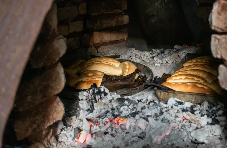 Rings of chipa bake on the floor of a tatakua, the domed clay oven used across rural Paraguay.