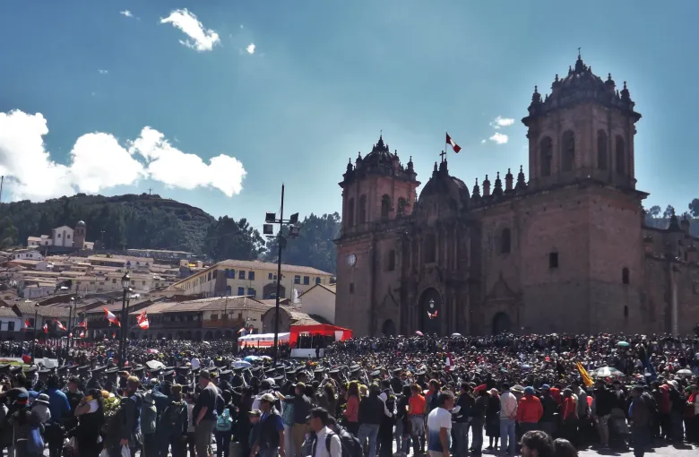 A crowd filling the Plaza de Armas in Cusco in front of the cathedral during Independence Day.