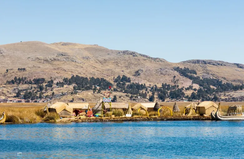 Low reed islands of the Uros lying along the still water of Lake Titicaca under a wide sky.