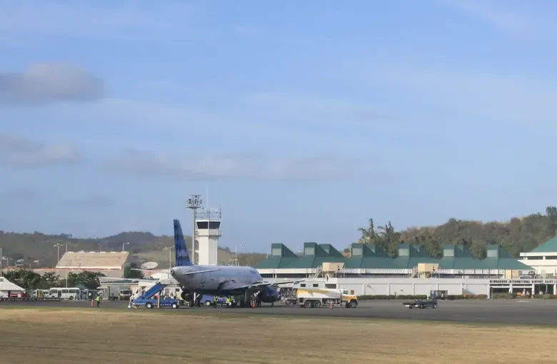Aircraft on the apron at Hewanorra International Airport in Vieux Fort, Saint Lucia, with hills behind.