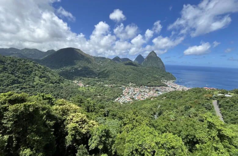 The town of Soufriere below the two Pitons, with the Caribbean Sea beyond, in Saint Lucia.