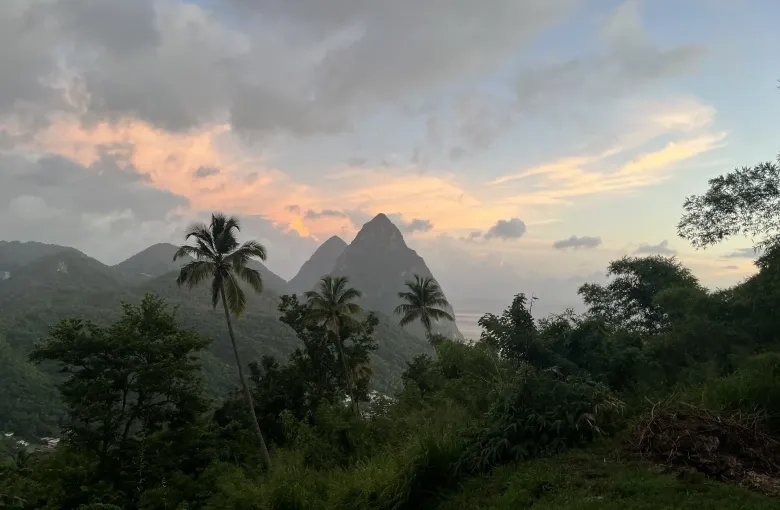 Gros Piton and Petit Piton rising above forest at sunset in the Soufriere district of Saint Lucia.